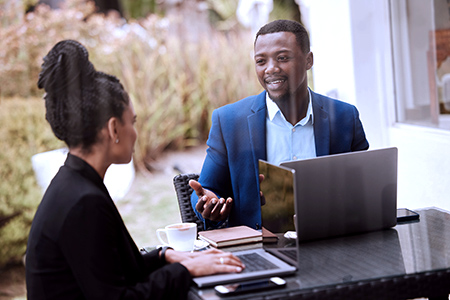 Business man and woman in a meeting with laptop