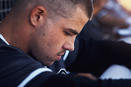 Young man with sad look holding head down